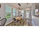 Bright dining area with natural lighting, wood table and chairs, and a glass exterior door at 5710 Tortoise Pl, Apollo Beach, FL 33572