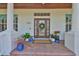 Inviting front entrance with a decorative door, brick pathway, and lush potted plants at 5710 Tortoise Pl, Apollo Beach, FL 33572