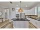 Kitchen featuring white cabinets, black countertops, stainless steel appliances, and island at 5710 Tortoise Pl, Apollo Beach, FL 33572