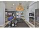 Kitchen featuring a black granite island, stainless steel appliances, pendant lighting, and open living concept at 5710 Tortoise Pl, Apollo Beach, FL 33572