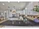 Bright kitchen with white cabinets, black countertops, stainless steel appliances, and wood flooring at 5710 Tortoise Pl, Apollo Beach, FL 33572