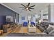 Living room showcasing a large TV, comfortable seating, light wood floors, and open access to other rooms at 5710 Tortoise Pl, Apollo Beach, FL 33572