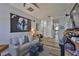 Cozy Gathering room featuring comfortable seating, arcade games, and hardwood floors at 5710 Tortoise Pl, Apollo Beach, FL 33572