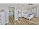Bright bedroom boasts hardwood floors, ensuite bathroom, a ceiling fan, and neutral paint at 5710 Tortoise Pl, Apollo Beach, FL 33572