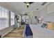 Bright bedroom offers lots of natural light, hardwood floors, and ample space for relaxation and fitness at 5710 Tortoise Pl, Apollo Beach, FL 33572