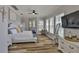 Bedroom with hardwood floors, large windows, a ceiling fan, sitting area, and neutral paint at 5710 Tortoise Pl, Apollo Beach, FL 33572