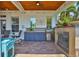 Outdoor kitchen and bar area with stainless steel appliances, sink, and a wood-look ceiling at 5710 Tortoise Pl, Apollo Beach, FL 33572