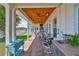 Outdoor kitchen under a wood-look ceiling with stainless steel appliances, a canal view and patio furniture at 5710 Tortoise Pl, Apollo Beach, FL 33572