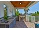 Outdoor kitchen with stainless steel grill, sink, concrete countertop, fire place, and a view of the canal at 5710 Tortoise Pl, Apollo Beach, FL 33572