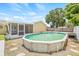 This backyard is fitted with an above ground pool, a wood deck, and a screened-in patio at 6012 Flora Ter, Apollo Beach, FL 33572