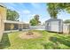 Expansive backyard showcasing a fire pit, shed, screened porch, and pool, ideal for entertaining and enjoying outdoor living at 6012 Flora Ter, Apollo Beach, FL 33572