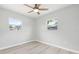 Bedroom featuring wood-look floors and abundant natural light from two windows at 6012 Flora Ter, Apollo Beach, FL 33572