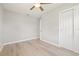 Bedroom features wood-look floors and an updated ceiling fan at 6012 Flora Ter, Apollo Beach, FL 33572