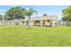 A well manicured front yard highlights this home's exterior and blue door at 6012 Flora Ter, Apollo Beach, FL 33572