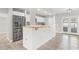 Modern kitchen featuring white cabinetry, a butcher block countertop, stainless steel appliances, and an open-concept layout at 6012 Flora Ter, Apollo Beach, FL 33572
