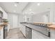 Contemporary kitchen with white cabinets, stainless steel appliances, and a stylish breakfast bar overlooking the dining area at 6012 Flora Ter, Apollo Beach, FL 33572