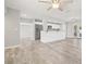 Spacious living room with modern gray floors, stainless steel appliances, and an open layout that connects to the kitchen at 6012 Flora Ter, Apollo Beach, FL 33572