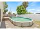 Backyard features a private above-ground pool, perfect for relaxation and outdoor enjoyment, nestled in a fenced yard at 6012 Flora Ter, Apollo Beach, FL 33572