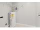 Utility room with new water heater and shelving at 6012 Flora Ter, Apollo Beach, FL 33572