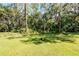 The property features a fenced backyard, a firepit and plenty of trees at 604 Kinnear Dr, Brooksville, FL 34601