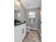 Modern bathroom featuring a granite countertop vanity and a glass door walk-in shower at 604 Kinnear Dr, Brooksville, FL 34601