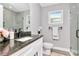 This modern bathroom features granite countertops and a walk-in shower at 604 Kinnear Dr, Brooksville, FL 34601