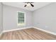Bright bedroom featuring a large window and hardwood floors at 604 Kinnear Dr, Brooksville, FL 34601