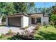 Well-maintained single-story home with a brick driveway, manicured lawn, and an arched entryway at 604 Kinnear Dr, Brooksville, FL 34601