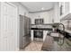 Modern kitchen featuring white cabinets, granite countertops, stainless steel appliances and ample storage space at 604 Kinnear Dr, Brooksville, FL 34601