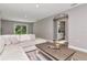 Bright living room with a large window, hardwood floors, and a view of the bathroom at 604 Kinnear Dr, Brooksville, FL 34601