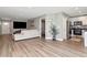 Open-concept living area flowing into a modern kitchen with stainless steel appliances and white cabinetry at 604 Kinnear Dr, Brooksville, FL 34601