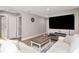 Spacious living room with hardwood floors, a large TV, and neutral wall paint at 604 Kinnear Dr, Brooksville, FL 34601