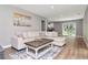 Bright living room featuring a comfortable sectional sofa, stylish coffee table, and sliding glass doors at 604 Kinnear Dr, Brooksville, FL 34601