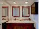 Bathroom featuring double sinks, granite countertops, and wood cabinets, offering style and functionality at 650 Island Way # 606, Clearwater Beach, FL 33767