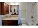 Cozy bathroom showcases vanity with granite countertop and a tiled shower/tub combo at 650 Island Way # 606, Clearwater Beach, FL 33767