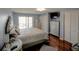 Bedroom with hard wood floors, television, chest of drawers, and closet space at 650 Island Way # 606, Clearwater Beach, FL 33767