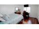 Bright bedroom boasts hardwood floors and natural light from the window, creating a cozy space at 650 Island Way # 606, Clearwater Beach, FL 33767