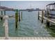 Waterfront dock with boat lift ready for easy access to waterways and endless nautical adventures at 650 Island Way # 606, Clearwater Beach, FL 33767