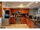 Updated kitchen featuring granite countertops, stainless steel appliances, and wood cabinets at 650 Island Way # 606, Clearwater Beach, FL 33767