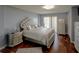 Main bedroom has hardwood floors and a decorative headboard with access to a balcony at 650 Island Way # 606, Clearwater Beach, FL 33767