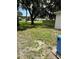 View of the partially grassed backyard space with mature shade trees and privacy fencing at 7651 46Th N Way, Pinellas Park, FL 33781