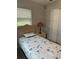 Cozy bedroom with a twin-sized bed and a lamp on the nightstand at 7651 46Th N Way, Pinellas Park, FL 33781