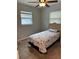 Bedroom with a ceiling fan and natural light from the window at 7651 46Th N Way, Pinellas Park, FL 33781