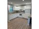 Updated kitchen with white appliances and laminate flooring at 7651 46Th N Way, Pinellas Park, FL 33781