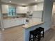 Well-lit kitchen with white cabinets, countertops, and modern appliances at 7651 46Th N Way, Pinellas Park, FL 33781