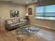 Inviting living area with a neutral color scheme, laminate floor, and modern furnishings at 7651 46Th N Way, Pinellas Park, FL 33781