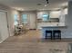 Open living area with newer flooring, with access to the updated kitchen and front door at 7651 46Th N Way, Pinellas Park, FL 33781