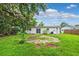 Spacious backyard featuring a fire pit and lush lawn at 7891 67Th N St, Pinellas Park, FL 33781