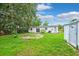 Backyard with a patio area, a fire pit, and green grass at 7891 67Th N St, Pinellas Park, FL 33781