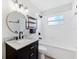 Renovated bathroom featuring a vanity, updated fixtures, and a shower-tub combination, offering a clean and modern design at 7891 67Th N St, Pinellas Park, FL 33781